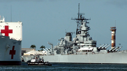 The Military Sealift Command (MSC) hospital ship USNS Mercy (T-AH 19) passes the battleship USS Missouri (BB 63) January 11, 2005 in Pearl Harbor, Hawaii. (Devin Wright/U.S. Navy via Getty Images)