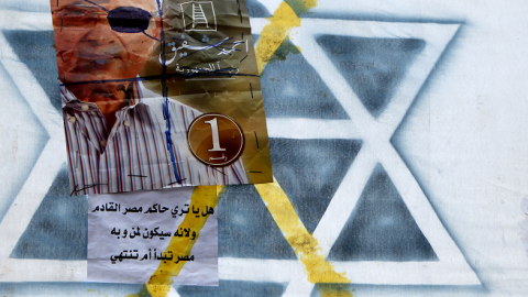 A defaced poster on Israel's Star of David symbol shows Egypt's presidential candidate Ahmed Shafiq looking like late Israeli defense minister Moshe Dayan in Cairo's landmark Tahrir Square on June 23, 2012. (MARWAN NAAMANI/AFP/GettyImages)