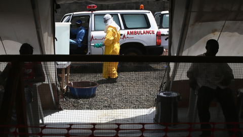 New arrivals suspected of having Ebola await entry as a health worker disinfects an ambulance in a high risk area of the Doctors Without Borders (MSF), treatment center on October 5, 2014 in Paynesville, Liberia. (John Moore/Getty Images)