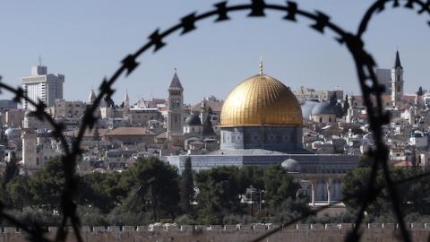 The Jerusalem Old City is seen through barbed wire on November 10, 2014. (THOMAS COEX/AFP/Getty Images)