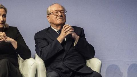 Jean-Marie Le Pen (R) and Marine Le Pen (L) listen to a speech, on November 29, 2014 in Lyon, during the 15th French National Front (FN) congress. (JEFF PACHOUD/AFP/Getty Images)