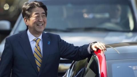Japanese Prime Minister Shinzo Abe looks on before taking a ride in a Model S P85D with Tesla CEO Elon Musk at Tesla's headquarters in Palo Alto, California on April 30, 2015. (Josh Edelson/AFP/Getty Images)