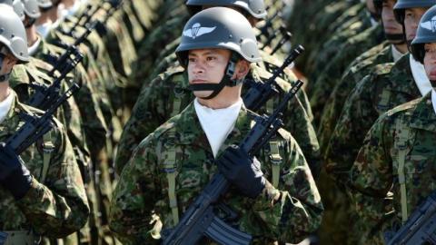 Japanese soldiers listen to Prime Minister Shinzo Abe at the Ground Self-Defence Force's Asaka training ground on October 27, 2013. (TORU YAMANAKA/AFP/Getty Images)