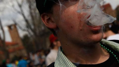 A student smokes a marijuana cigarette during a 'smoke out' with thousands of others April 20, 2010 at the University of Colorado in Boulder, Colorado. (Chris Hondros/Getty Images)