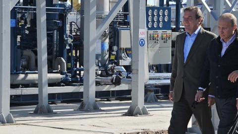 Then-Russian Prime Minister Vladimir Putin (C), Gazprom CEO Alexei Miller (R) and former German chancellor Gerhard Schroeder (L) at the gas compressor station 'Portovaya' outside Vyborg, September 6, 2011. (ALEXEY NIKOLSKY/AFP/Getty Images)