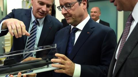 French President Francois Hollande, center, inspects a model of the Royal Australian Navy's Collins class submarine during a visit to French defense contractor Thales' office in Sydney on Nov. 18, 2014. (Dan Himbrechts - Pool/Getty Images)