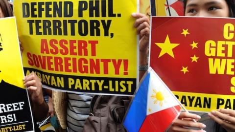 Filipino protesters display placards during a rally against China's claim to areas of the South China Sea, at the Chinese consulate in Manila on June 12, 2014. (JAY DIRECTO/AFP/Getty Images)