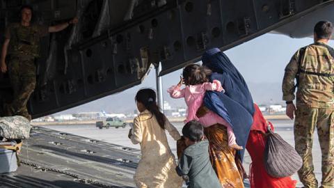 U.S. Air Force loadmasters and pilots load passengers aboard a U.S. Air Force C-17 Globemaster III (Photo by Master Sgt. Donald R. Allen/U.S. Air Forces Europe-Africa via Getty Images)