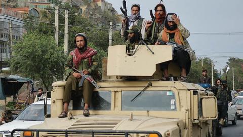 Taliban fighters atop a Humvee vehicle take part in a rally in Kabul on August 31, 2021. (Photo by Hoshang Hashimi/AFP via Getty Images)