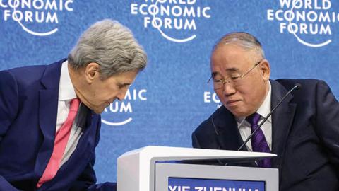 U.S. climate envoy John Kerry and China's special climate envoy Xie Zhenhua during a session at the World Economic Forum annual meeting in Davos on May 24, 2022. (Photo by Fabrice Coffrini/AFP via Getty Images)