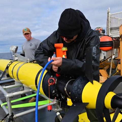 U.S. Navy members assigned to Unmanned Undersea Vehicle Flotilla 1 conduct troubleshooting and maintenance measures on the Razorback UUV before it is launched for an exercise aboard U.S. Coast Guard Cutter Forward (WMEC 911) in the Atlantic Ocean, Aug. 26, 2023.