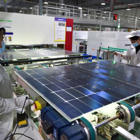 A worker is producing photovoltaic panel components at a workshop of a photovoltaic enterprise in Suqian, Jiangsu Province, China, on December 9, 2023. (Photo by Costfoto/NurPhoto via Getty Images)