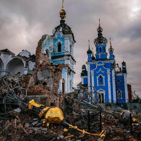 Construction workers climb onto the roof of a destroyed church on January 4, 2023, in the village of Bohorodychne, Donetsk region. (Dimitar Dilkoff/AFP via Getty Images)