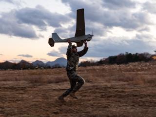 U.S. Marine Corps Cpl. Jakob Santos, a small unmanned aerial system operator with 4th Marines, 3d Marine Division, prepares to launch a RQ-20B Puma during Artillery Relocation Training Program 24.3 at Ojojihara Maneuver Area, Miyagi Prefecture, Japan, Nov. 29, 2024. Unmanned aircraft provide enhanced situational awareness, quick resupply capabilities, and reduce the footprint of military personnel. The skills developed at ARTP increase the proficiency and readiness of the only permanently forward-deployed a