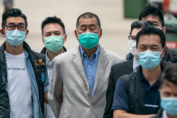 Hong Kong media tycoon and Apple Daily founder Jimmy Lai is escorted by the police to the Royal Hong Kong Yacht Club Shelter Cove Clubhouse for evidence collection as part of the ongoing investigations on August 11, 2020, in Hong Kong, China. (Anthony Kwan via Getty Images)