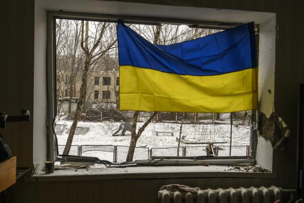 A Ukrainian flag is hanging in the window of an apartment building that has been heavily damaged during Russia's massive rocket attack on Kyiv, in Kyiv, Ukraine, on January 3, 2024. (Maxym Marusenko/NurPhoto via Getty Images)