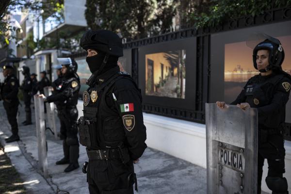 Riot police officers stand guard outside the Ecuadorian embassy in Mexico City on April 6, 2024, following the severance of diplomatic relations between the two countries. Ecuadorian authorities stormed the Mexican embassy in Quito on April 5 to arrest former vice president Jorge Glas, who had been granted political asylum there, prompting Mexico to sever diplomatic ties after the "violation of international law". (Photo by Yuri CORTEZ / AFP) (Photo by YURI CORTEZ/AFP via Getty Images)
