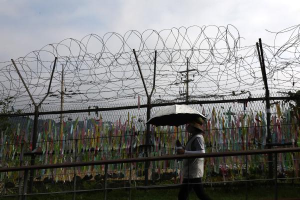 A woman walks past prayer ribbons wishing for reunification of the two Koreas on July 19, 2023, in Paju, South Korea. (Chung Sung-Jun via Getty Images)