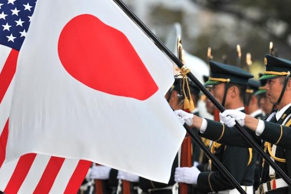 A unit of the Japanese Ground Self Defense Force honor guards hold national flags for visiting US Army General Martin E. Dempsey, chairman of the Joint Chiefs of Staff at the Defence Ministry in Tokyo on October 28, 2011. (KAZUHIRO NOGI/AFP/Getty Images)