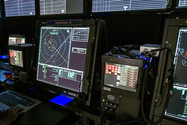 An Air Traffic Controller monitors computer screens inside the Carrier Air Traffic Control Center (CATCC) used with the US Navy's Northrop Grumman X-47B, July 31, 2012 at Naval Air Station Patuxent River, Maryland.