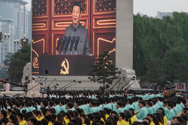 Chinese leader Xi Jinping is seen on a screen as the crowd listens during his speech at a ceremony marking the 100th anniversary of the Communist Party at Tiananmen Square on July 1, 2021 in Beijing, China. (Getty Images)