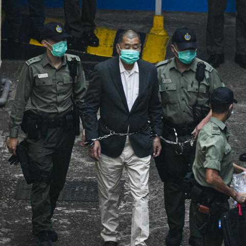 Jimmy Lai, founder and owner of Apple Daily, is seen handcuffed and escorted by guards on December 12, 2020, in Hong Kong, China. (Keith Tsuji via Getty Images)