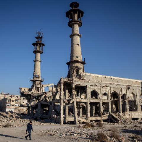 A man walks in front of the destroyed Sakina Shrine on December 25, 2024, in Damascus, Syria. (Chris McGrath via Getty Images)