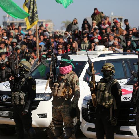 People watch as they secure an area before handing over Israeli hostages to a Red Cross team in Khan Yunis in the southern Gaza Strip on February 15, 2025. (Getty Images)