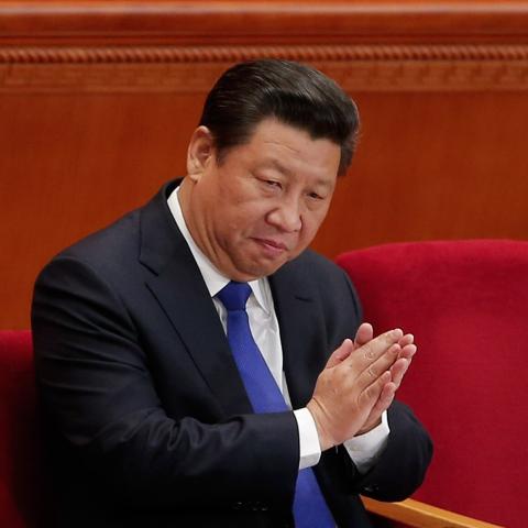 Chinese President Xi Jinping applauds during the opening of the National People's Congress on March 5, 2015, in Beijing, China. (Lintao Zhang via Getty Images).