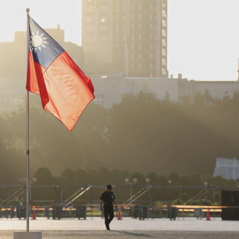 A man walks past a hoisted Taiwanese flag at the Chiang Kai-shek Memorial Hall in Taipei on October 15, 2024. (I-Hwa Cheng/AFP via Getty Images)